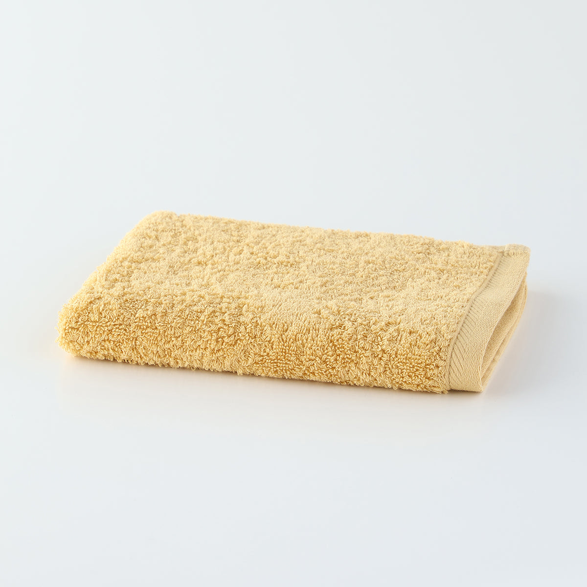 Plant-dyed Organic Pile guest towel in Yellow