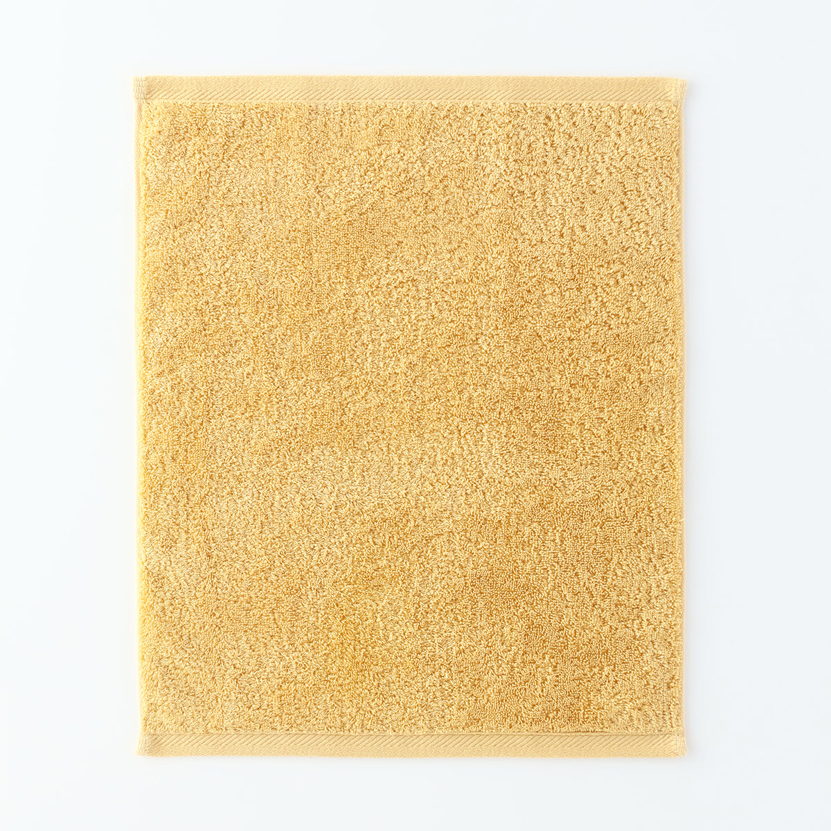Plant-dyed Organic Pile guest towel in Yellow