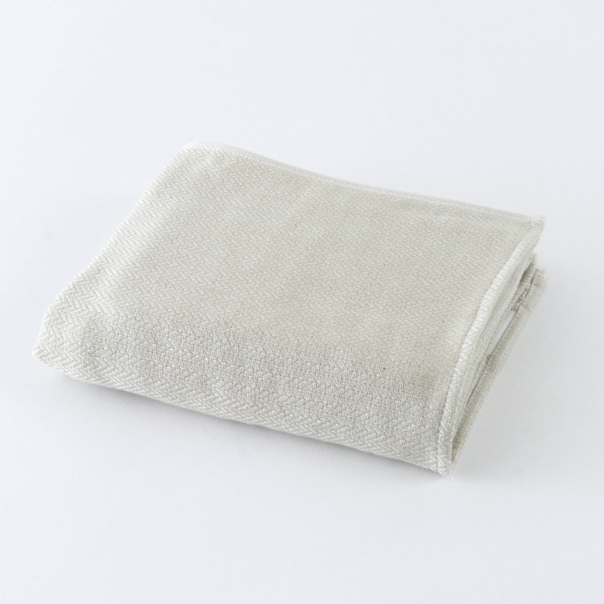 Tea-dyed organic gauze face towel in Green