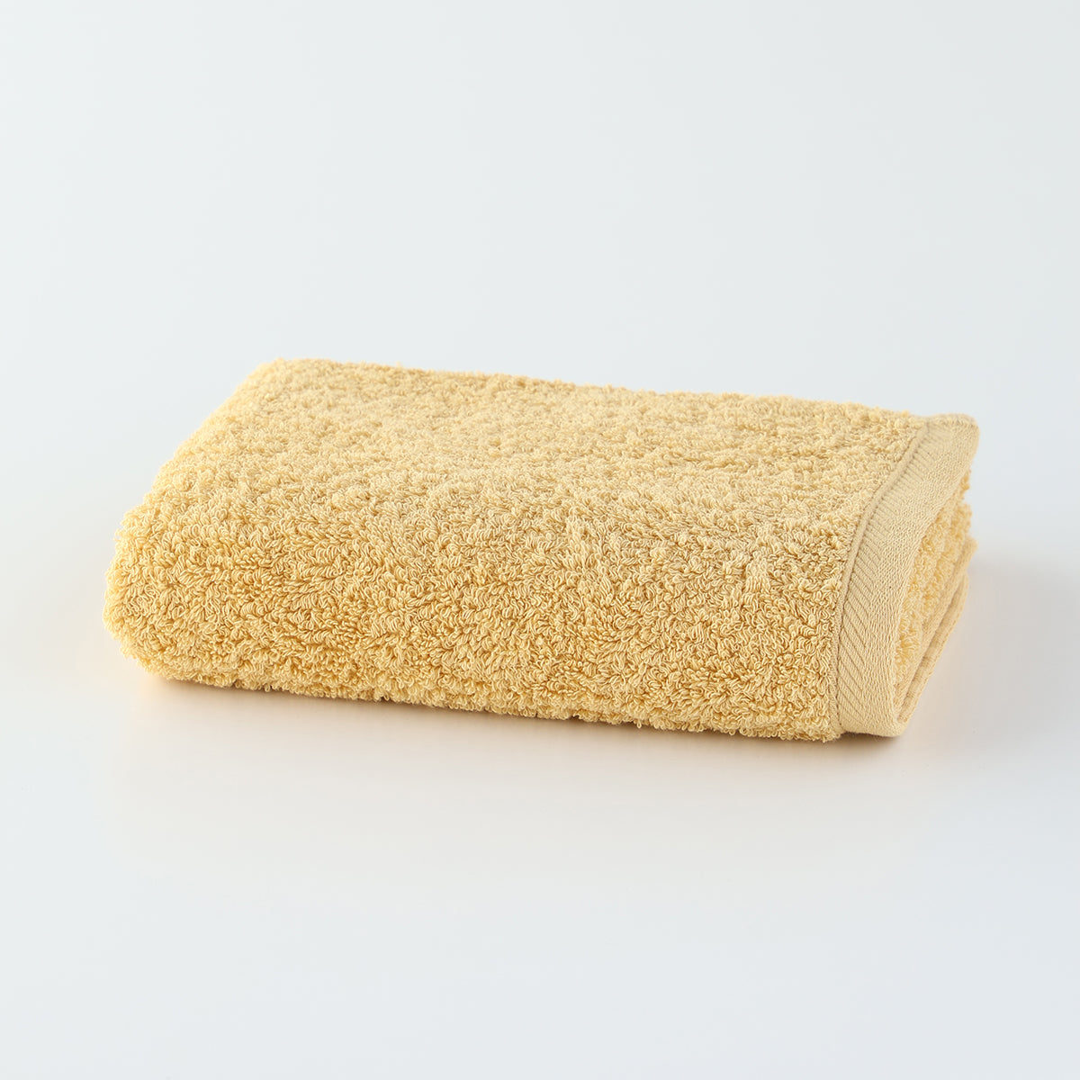 Plant-dyed Organic Pile face towel in Yellow