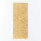 Plant-dyed Organic Pile face towel in Yellow