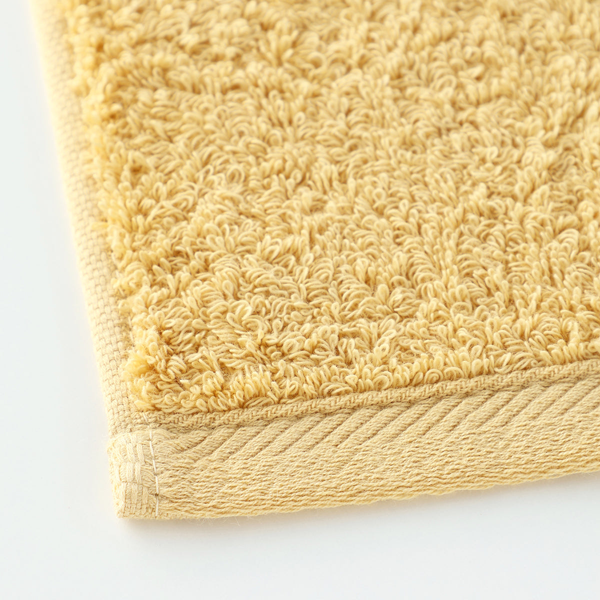 Plant-dyed Organic Pile face towel in Yellow