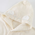Airy Touch baby poncho in Ivory
