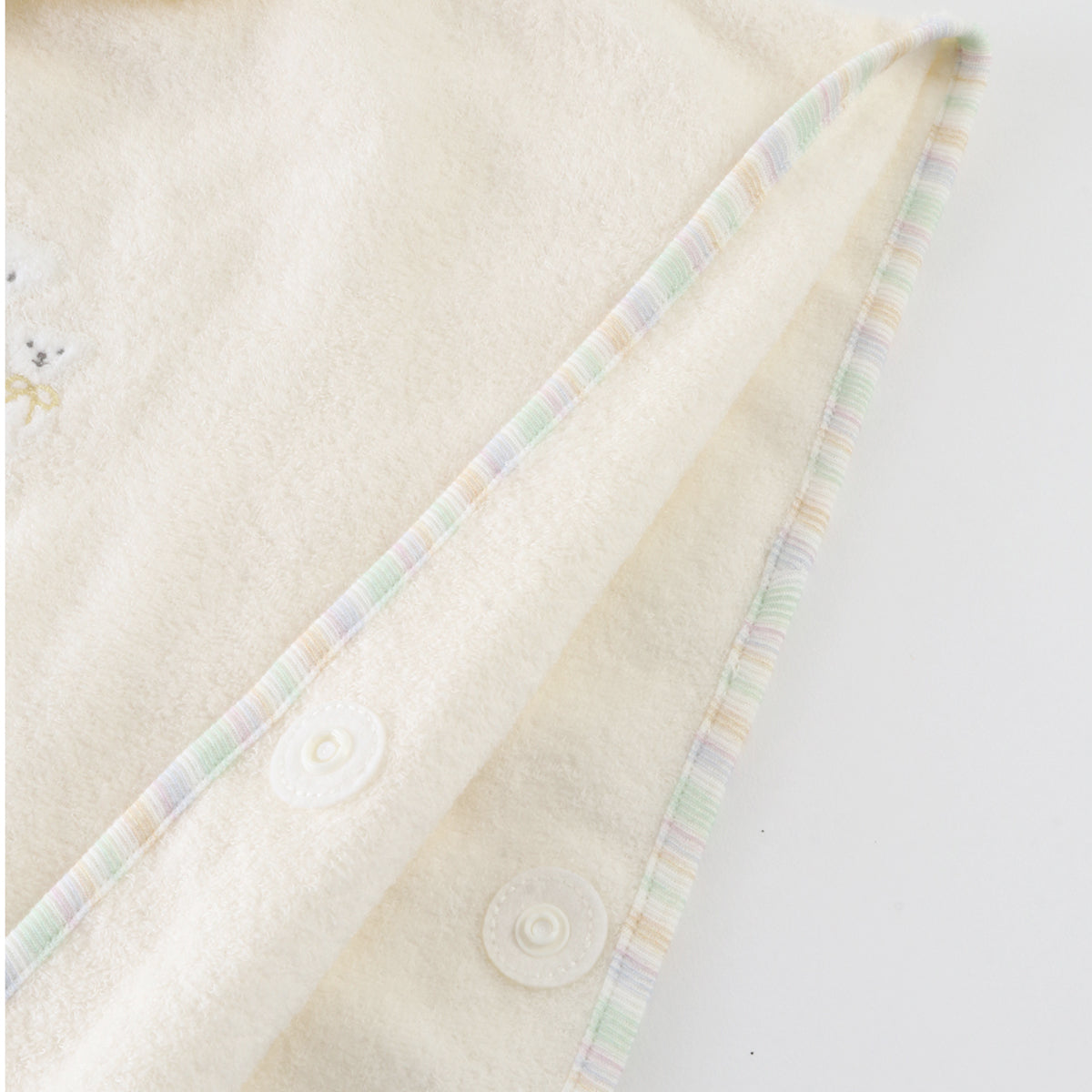 Airy Touch baby poncho in Ivory