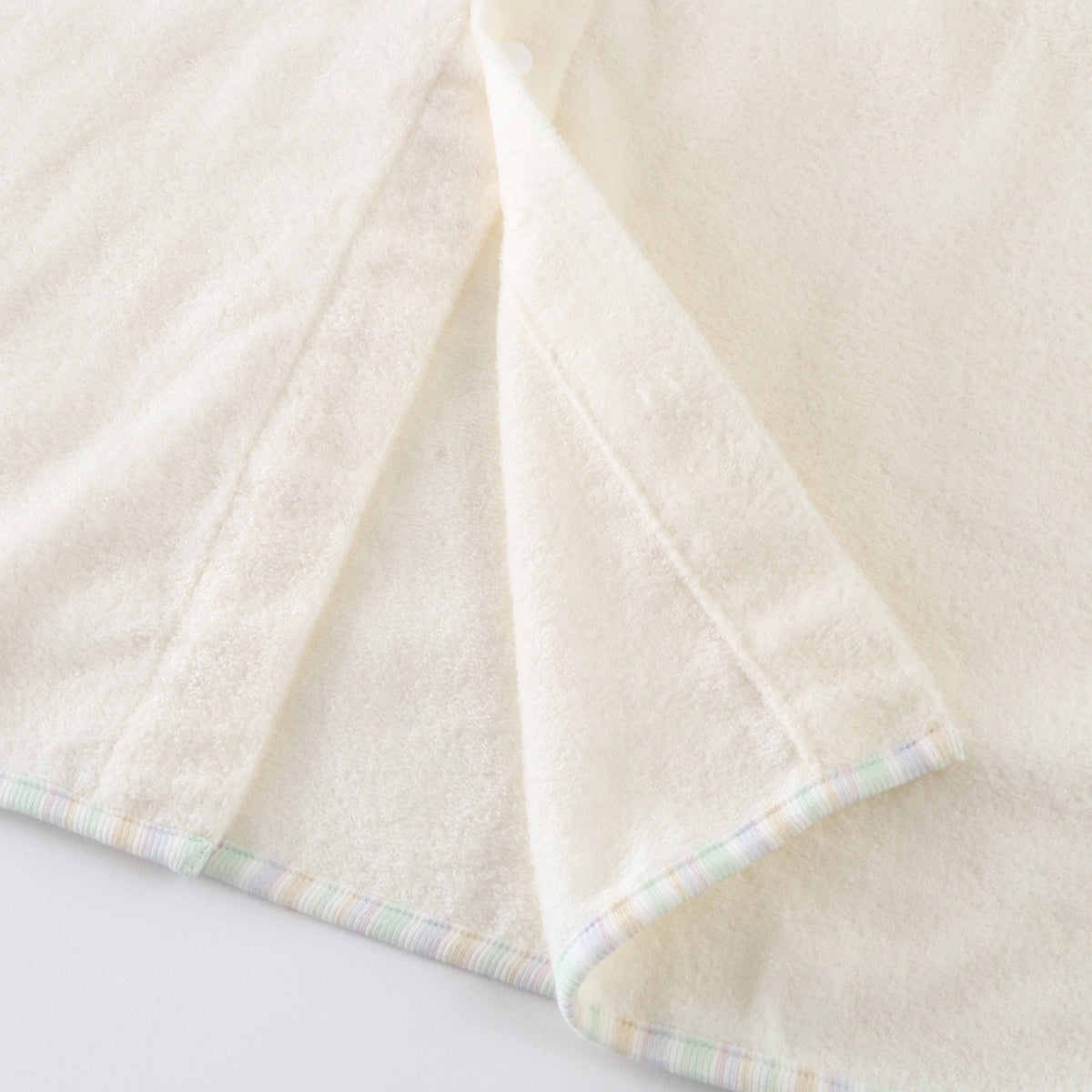 Airy Touch baby poncho in Ivory