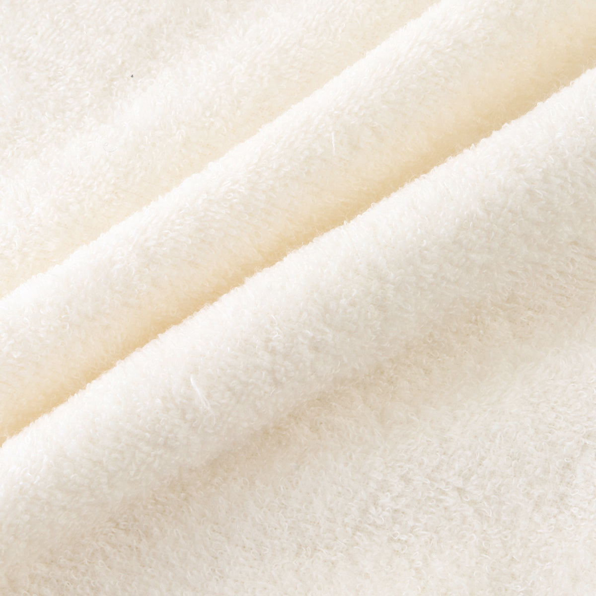 Airy Touch baby poncho in Ivory